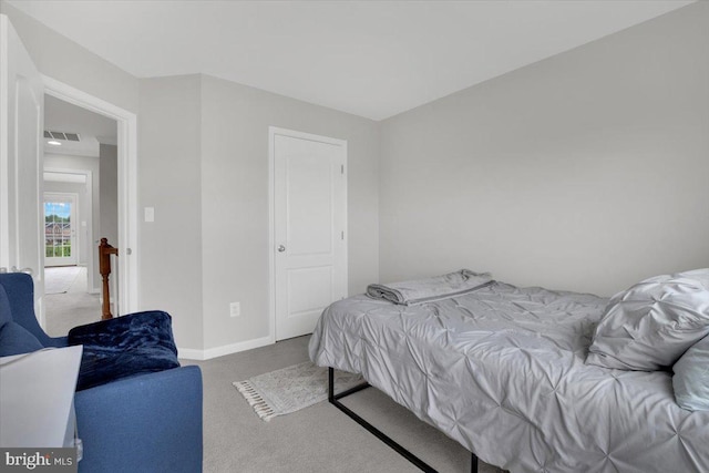 carpeted bedroom with baseboards and visible vents