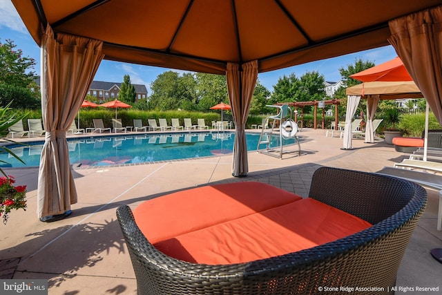 pool with a gazebo and a patio area