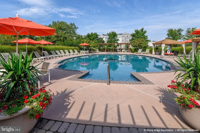 community pool featuring a gazebo and a patio area