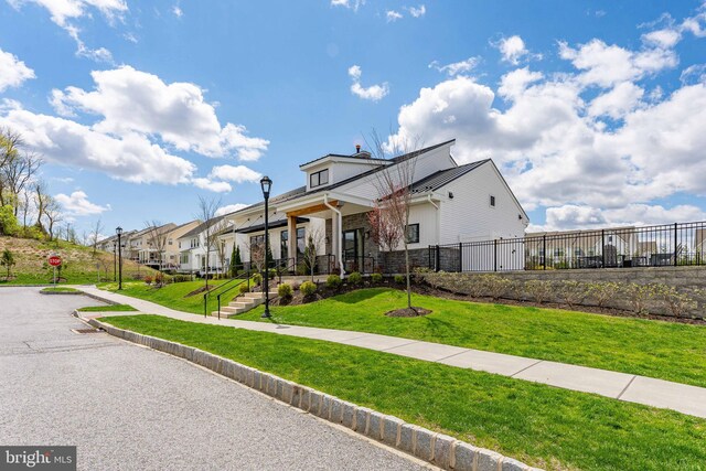 708 Hoopes Ln, Media, PA 19063 - view of front of home featuring a front lawn, fence, stone siding, and a residential view