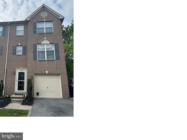 407 Tatum Ave, Wilmington, DE 19805 - view of front of home with asphalt driveway, brick siding, and a garage