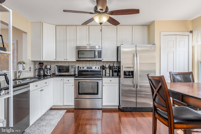 407 Tatum Ave, Wilmington, DE 19805 - kitchen with appliances with stainless steel finishes, a sink, dark countertops, and ceiling fan