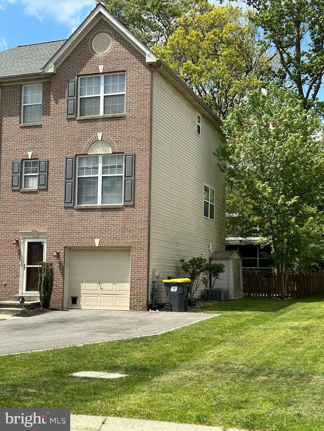 407 Tatum Ave, Wilmington, DE 19805 - view of side of home with an attached garage, brick siding, and asphalt driveway