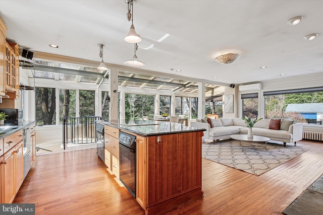 2314 Valley Rd, Huntingdon Valley, PA 19006 - interior space featuring light wood-type flooring, radiator heating unit, wall oven, and a kitchen island