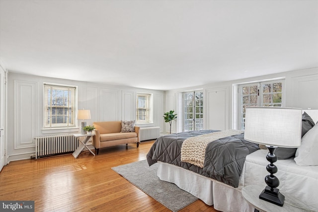 2314 Valley Rd, Huntingdon Valley, PA 19006 - bedroom featuring light wood-style flooring, a decorative wall, and radiator heating unit