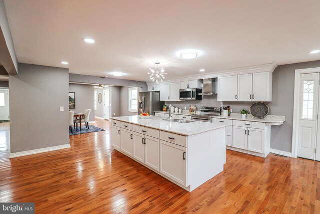 1111 S Mountain Rd, Dillsburg, PA 17019 - kitchen with appliances with stainless steel finishes, wall chimney exhaust hood, a sink, white cabinetry, and baseboards