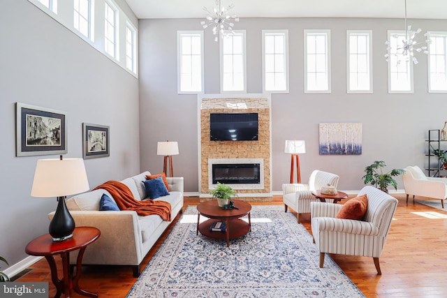 1111 S Mountain Rd, Dillsburg, PA 17019 - living room with a chandelier, a towering ceiling, wood finished floors, and healthy amount of natural light