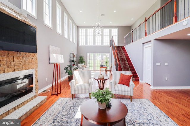 1111 S Mountain Rd, Dillsburg, PA 17019 - living room featuring stairs, baseboards, a towering ceiling, a stone fireplace, and recessed lighting