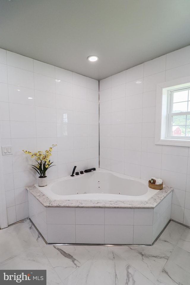 1111 S Mountain Rd, Dillsburg, PA 17019 - bathroom with a tub with jets, marble finish flooring, and tile walls