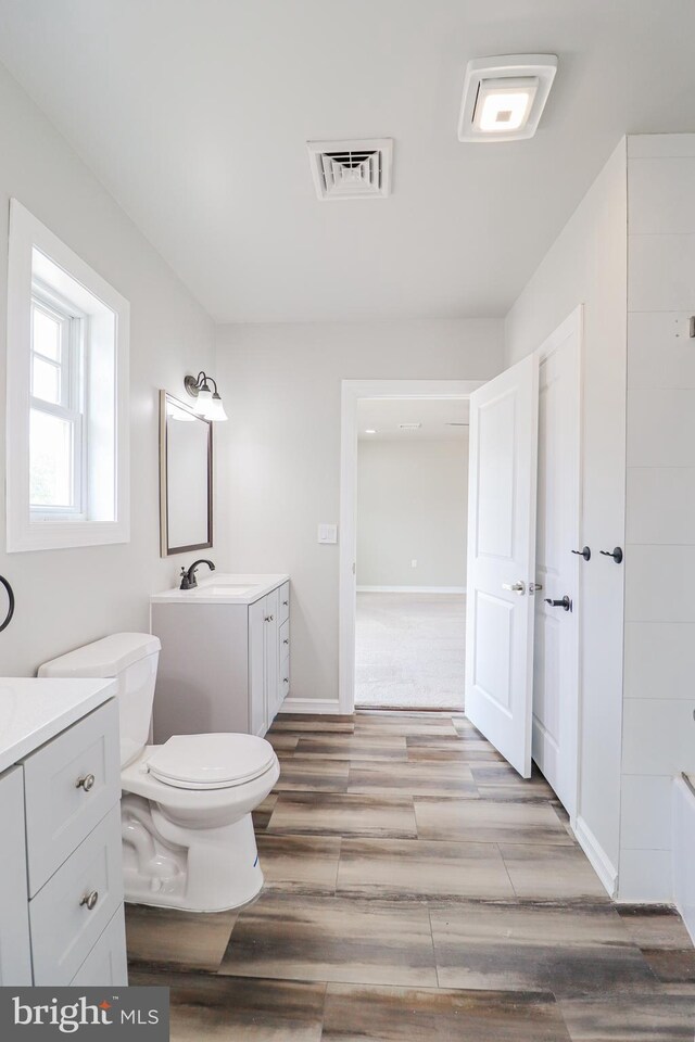 1111 S Mountain Rd, Dillsburg, PA 17019 - full bath featuring vanity, wood finished floors, toilet, and baseboards