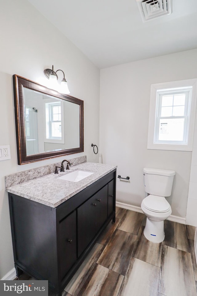 1111 S Mountain Rd, Dillsburg, PA 17019 - full bathroom featuring toilet, vanity, wood finished floors, and baseboards