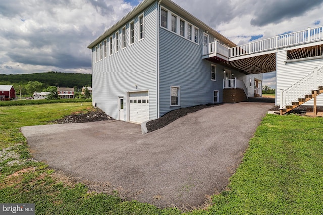 1111 S Mountain Rd, Dillsburg, PA 17019 - view of side of home featuring stairway, asphalt driveway, an attached garage, and a yard
