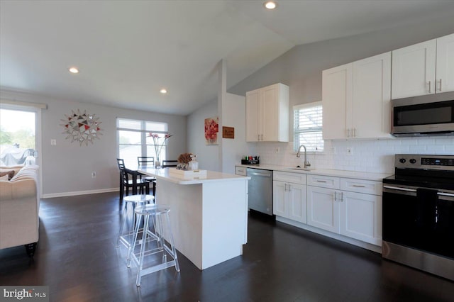 617 Castlewood Dr, Upper Marlboro, MD 20774 - kitchen with vaulted ceiling, light countertops, appliances with stainless steel finishes, and a healthy amount of sunlight