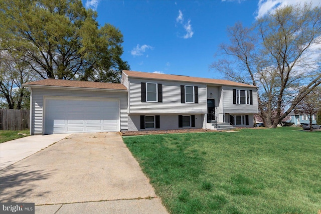 617 Castlewood Dr, Upper Marlboro, MD 20774 - split foyer home with an attached garage, a front yard, concrete driveway, and fence