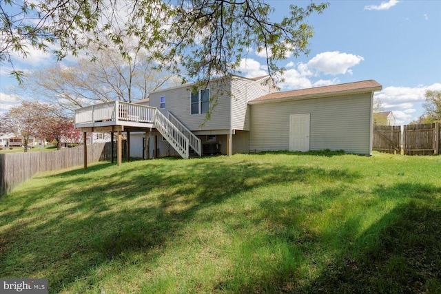 617 Castlewood Dr, Upper Marlboro, MD 20774 - back of house featuring a fenced backyard, a wooden deck, a yard, and stairs