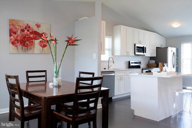 617 Castlewood Dr, Upper Marlboro, MD 20774 - kitchen with vaulted ceiling, a sink, stainless steel appliances, light countertops, and backsplash