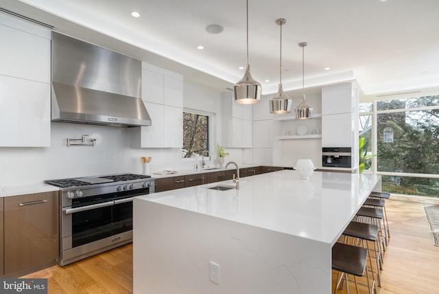 kitchen featuring open shelves, wall chimney exhaust hood, modern cabinets, and double oven range