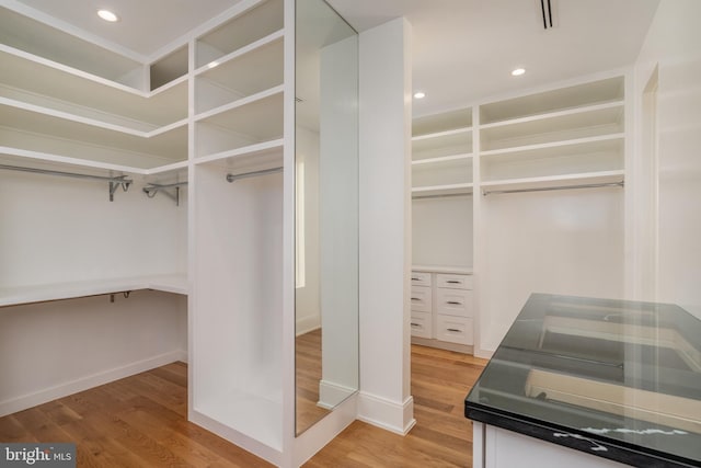 spacious closet with light wood-style floors and visible vents