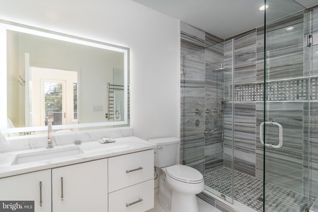 full bathroom featuring a shower stall, vanity, and toilet