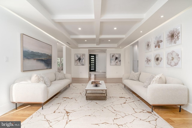 living area featuring coffered ceiling, wood finished floors, and beamed ceiling