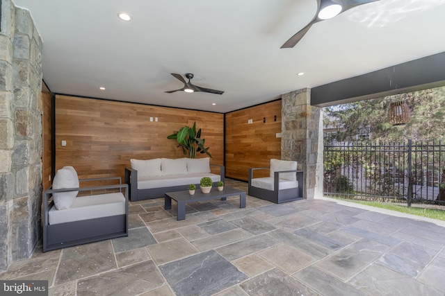 view of patio / terrace with outdoor lounge area, fence, and a ceiling fan