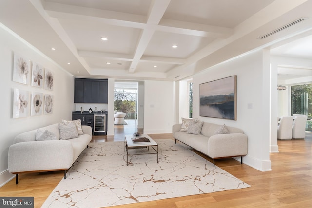 living room featuring a bar, plenty of natural light, visible vents, and wine cooler