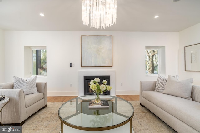 living area with light wood-style floors, plenty of natural light, and recessed lighting