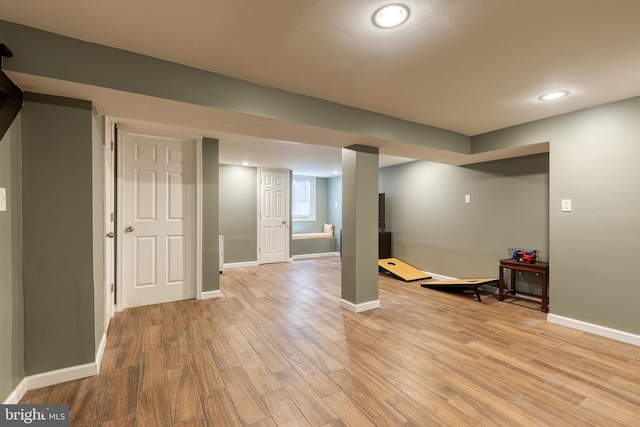 basement with light wood-style flooring, baseboards, and recessed lighting