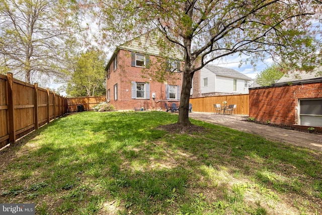 view of yard featuring a patio area and a fenced backyard