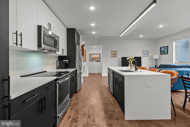 1501 N 31st St Unit 318, Philadelphia, PA 19121 - kitchen with light countertops, appliances with stainless steel finishes, dark cabinetry, and wood finished floors