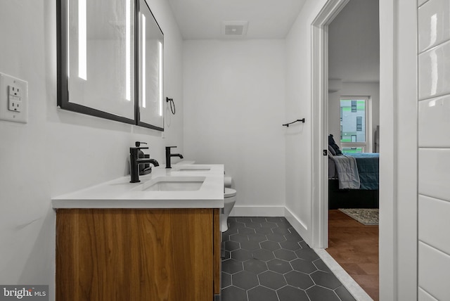 1501 N 31st St Unit 318, Philadelphia, PA 19121 - bathroom featuring ensuite bath, toilet, a sink, double vanity, and baseboards