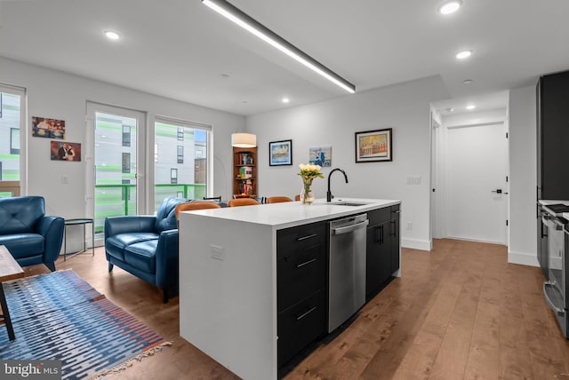 1501 N 31st St Unit 318, Philadelphia, PA 19121 - kitchen featuring dark cabinets, wood finished floors, dishwasher, a sink, and open floor plan
