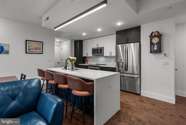 1501 N 31st St Unit 318, Philadelphia, PA 19121 - kitchen with light countertops, visible vents, a breakfast bar area, appliances with stainless steel finishes, and a sink
