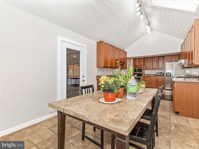19512 Desmet Pl, Montgomery Village, MD 20886 - dining room featuring lofted ceiling, track lighting, baseboards, and a skylight