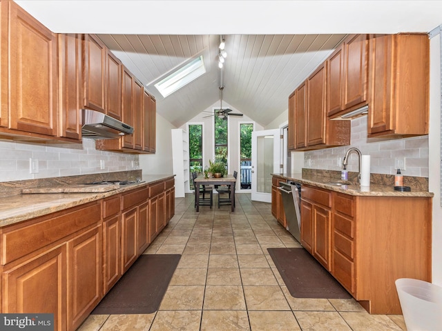 19512 Desmet Pl, Montgomery Village, MD 20886 - kitchen with under cabinet range hood, vaulted ceiling, a sink, a skylight, and stainless steel dishwasher