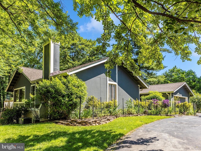 19512 Desmet Pl, Montgomery Village, MD 20886 - view of property exterior featuring a yard, a chimney, and central AC unit