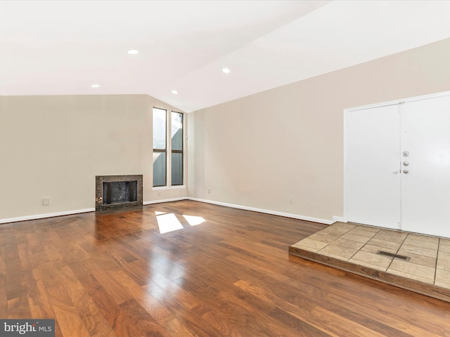 19512 Desmet Pl, Montgomery Village, MD 20886 - unfurnished living room featuring lofted ceiling, wood finished floors, a fireplace, baseboards, and recessed lighting