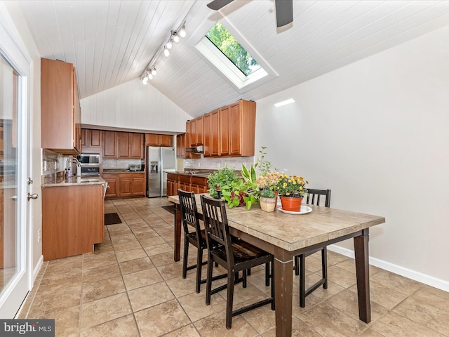 19512 Desmet Pl, Montgomery Village, MD 20886 - dining space featuring track lighting, lofted ceiling, a skylight, a ceiling fan, and baseboards