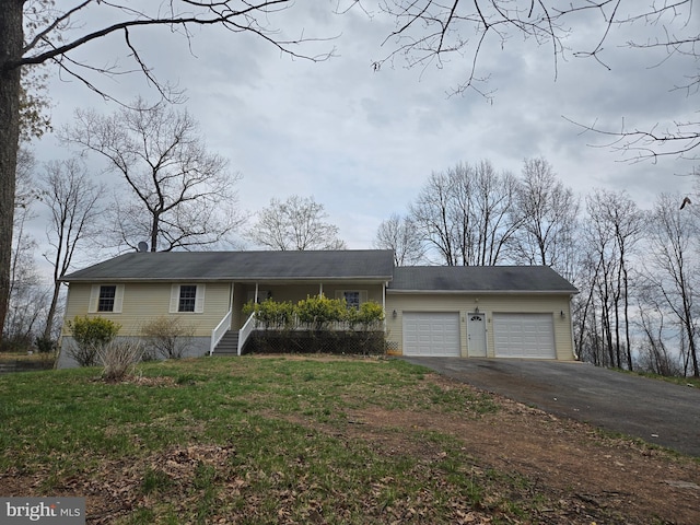 view of front of house with aphalt driveway, a front lawn, and an attached garage