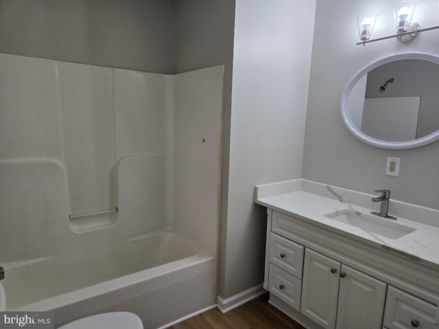 bathroom featuring shower / bath combination, vanity, and wood finished floors