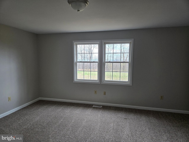 spare room with visible vents, baseboards, and carpet floors