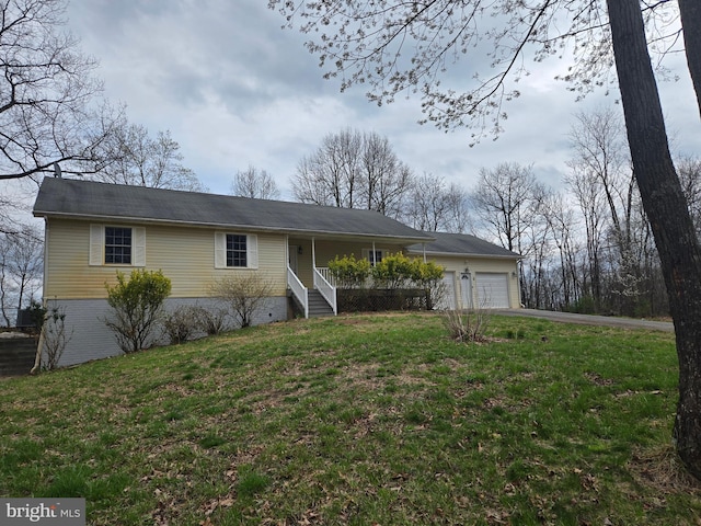 single story home with an attached garage, covered porch, a front yard, and concrete driveway
