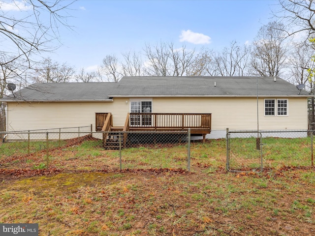 back of house with a fenced backyard and a wooden deck