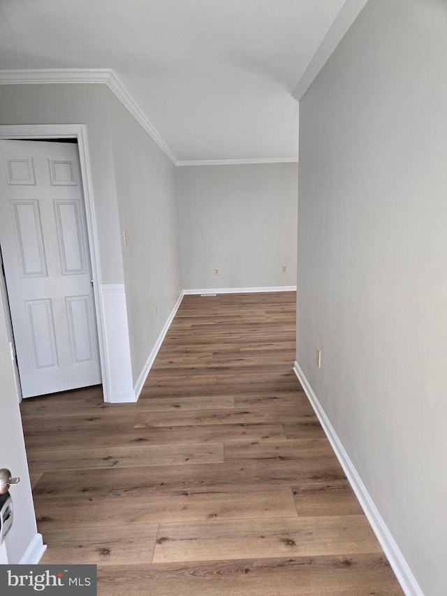 bonus room featuring baseboards and wood finished floors
