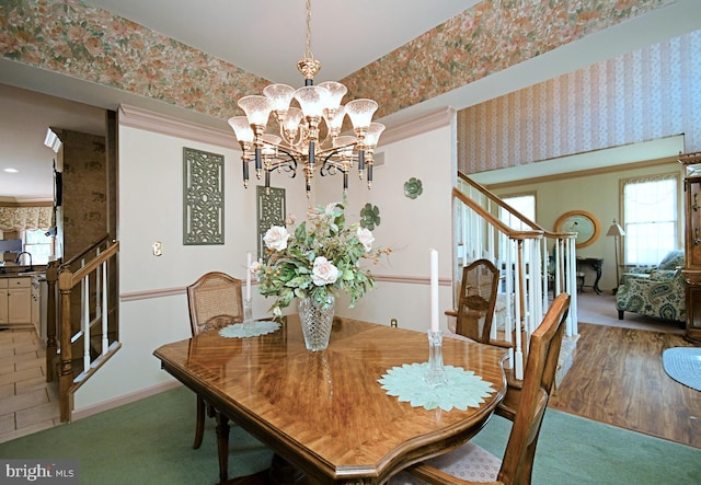 dining space featuring a healthy amount of sunlight, stairway, and wallpapered walls