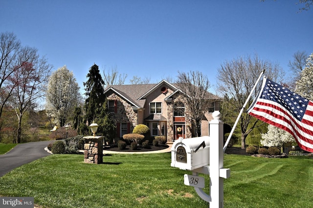view of front of property featuring a front yard and stone siding