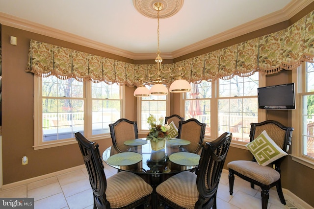dining room featuring a wealth of natural light, baseboards, and crown molding