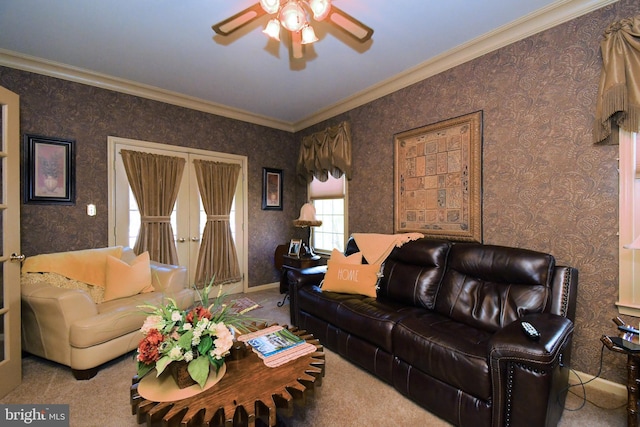 living area with crown molding, ceiling fan, baseboards, and wallpapered walls