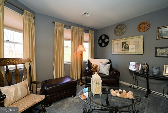 sitting room with a healthy amount of sunlight, carpet flooring, baseboards, and visible vents
