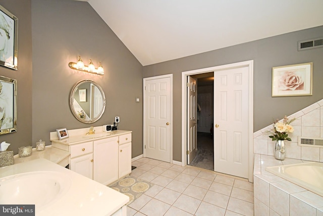 full bath with visible vents, a bath, a sink, tile patterned floors, and lofted ceiling